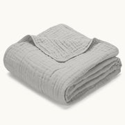 Morvelle Cloud White muslin cotton blanket folded on white